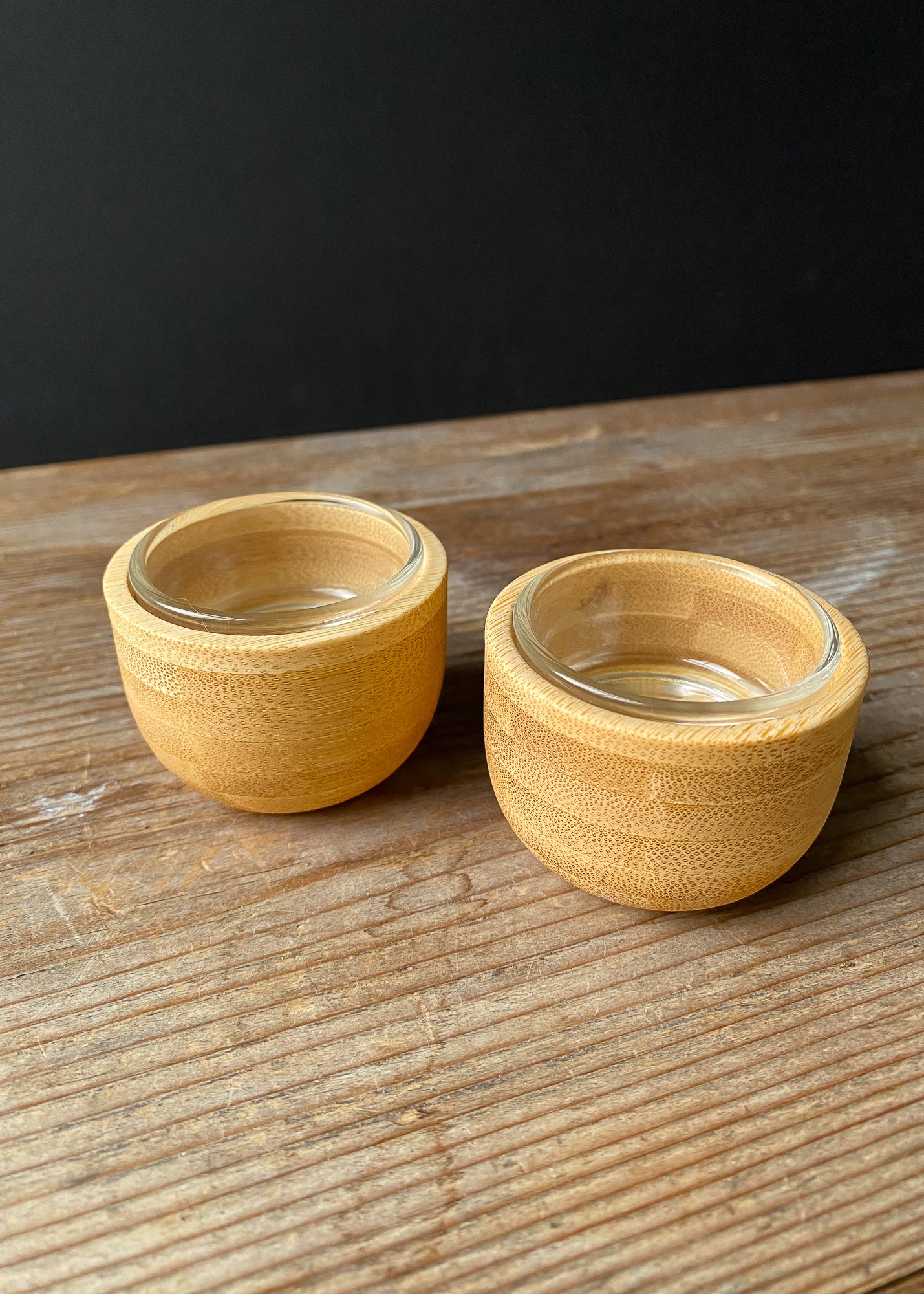 Handcrafted bamboo candle holder set of two with glass inserts.