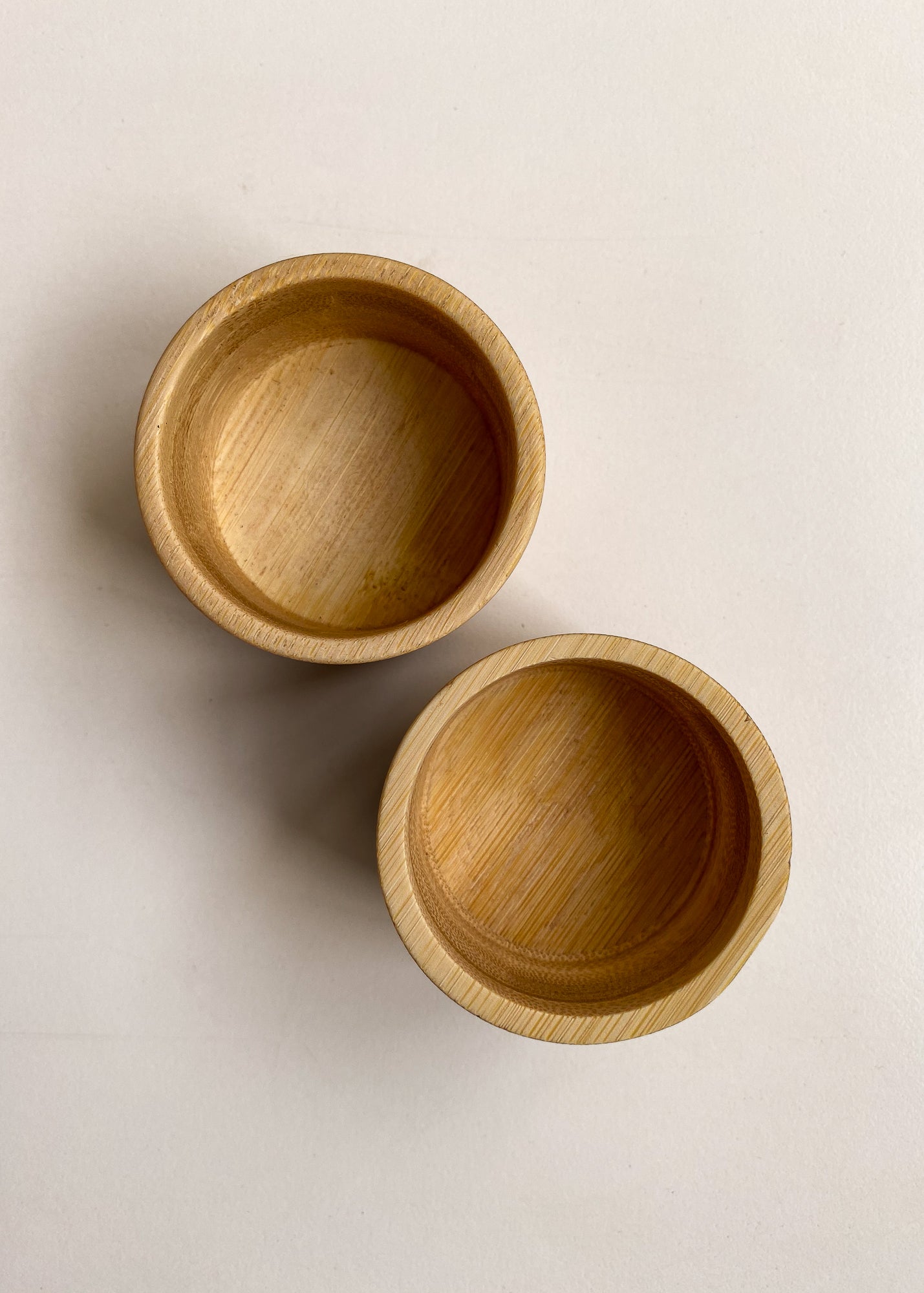 Set of two bamboo candle holders shown on white background