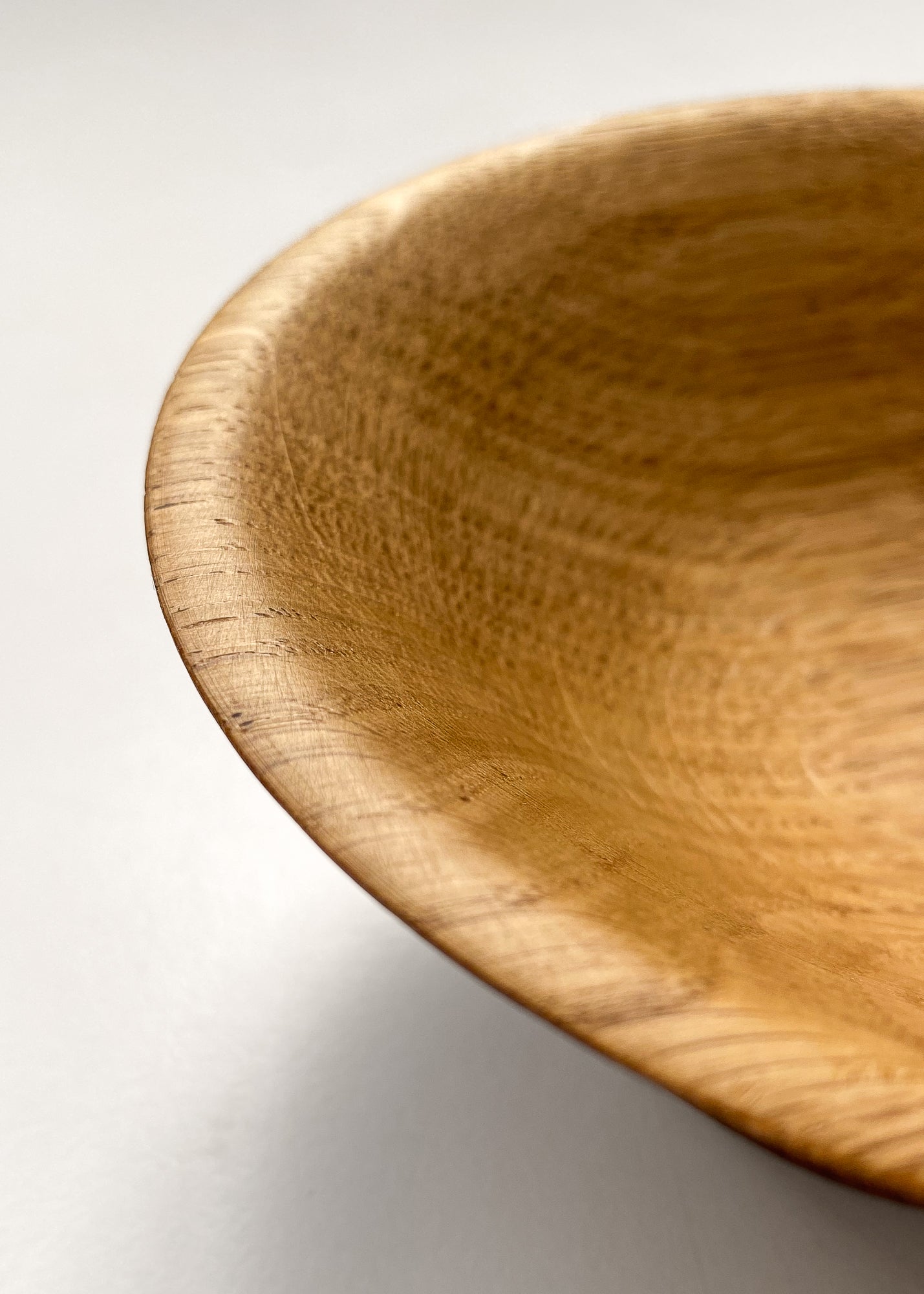 Close up inside view of Oak wood bowl on white background.